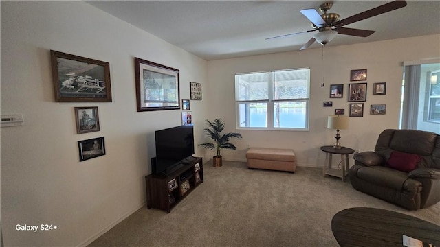 living room featuring light carpet and ceiling fan