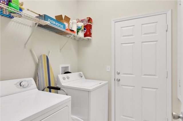 clothes washing area with washer and clothes dryer