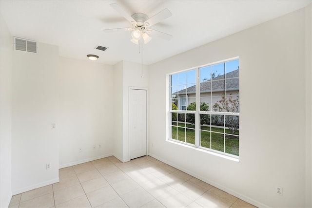 tiled empty room with ceiling fan