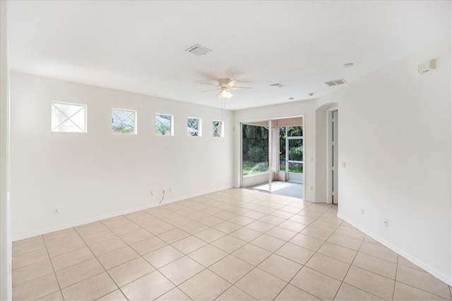 tiled spare room with ceiling fan