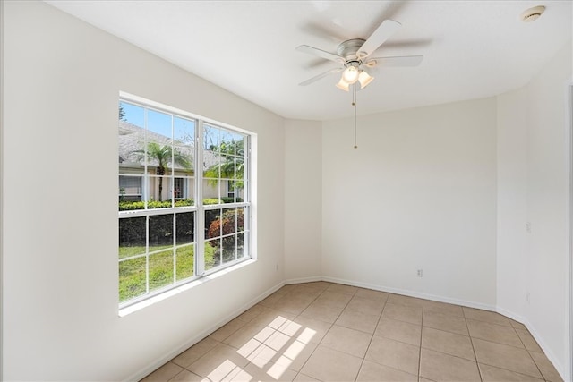 empty room with light tile patterned floors and ceiling fan