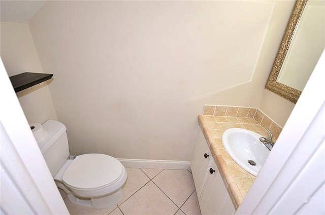 bathroom with vanity, tile patterned flooring, and toilet