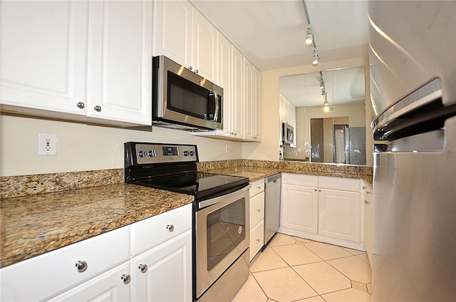 kitchen with white cabinetry, track lighting, stainless steel appliances, and light tile patterned floors