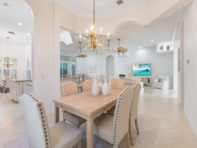 tiled dining area featuring ornamental molding and ceiling fan