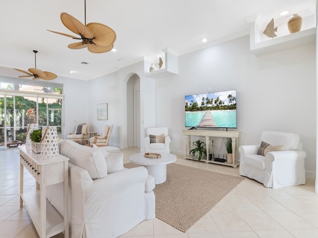 living room featuring ceiling fan, light tile patterned floors, and crown molding