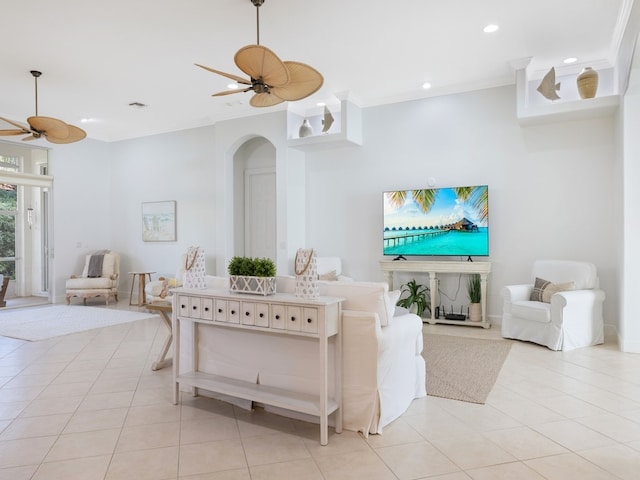 living room with ornamental molding, light tile patterned flooring, and ceiling fan