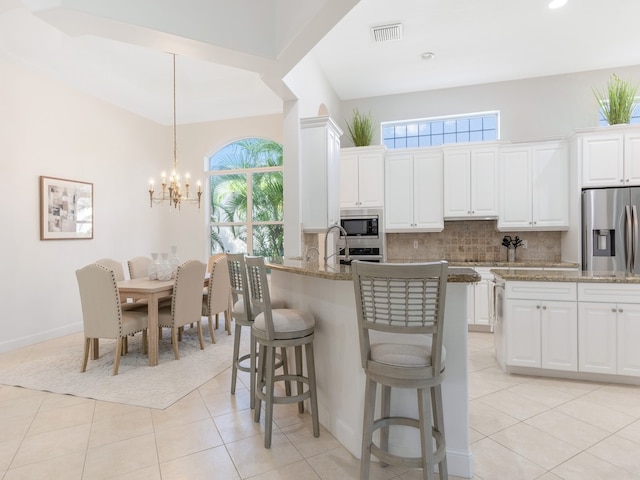 kitchen featuring white cabinetry, a wealth of natural light, and stainless steel appliances