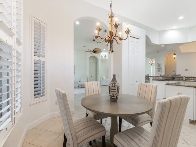 dining room featuring light tile patterned floors, ceiling fan, and sink