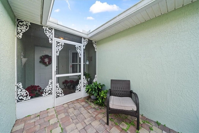 view of exterior entry featuring stucco siding