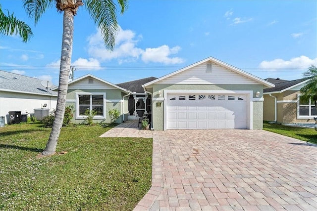 ranch-style house with central AC, a front yard, decorative driveway, and a garage