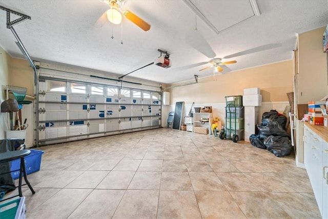 garage featuring a garage door opener and a ceiling fan