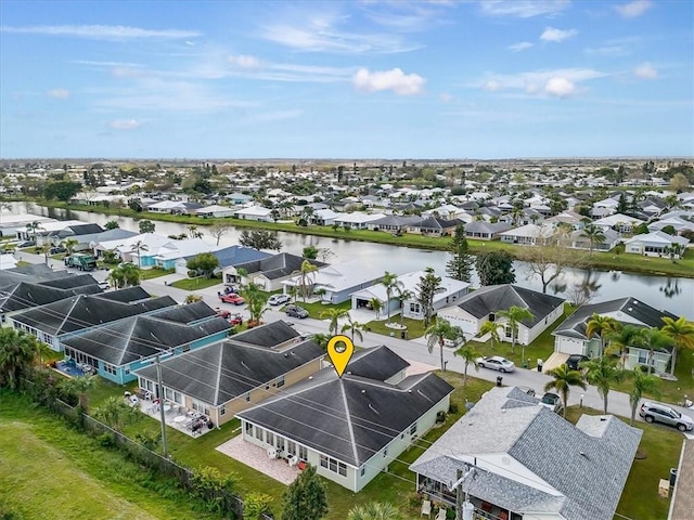 drone / aerial view with a residential view and a water view