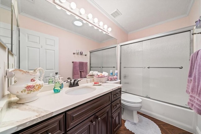 full bathroom with visible vents, crown molding, toilet, shower / bath combination with glass door, and vanity