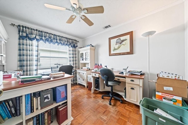 office area with a ceiling fan, visible vents, and ornamental molding