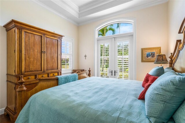 bedroom featuring access to exterior, french doors, ornamental molding, and wood finished floors