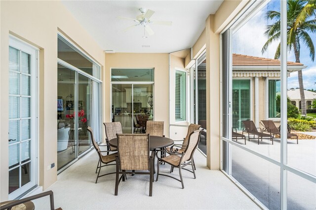 sunroom featuring a wealth of natural light and ceiling fan