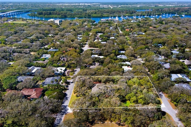 drone / aerial view with a water view and a wooded view