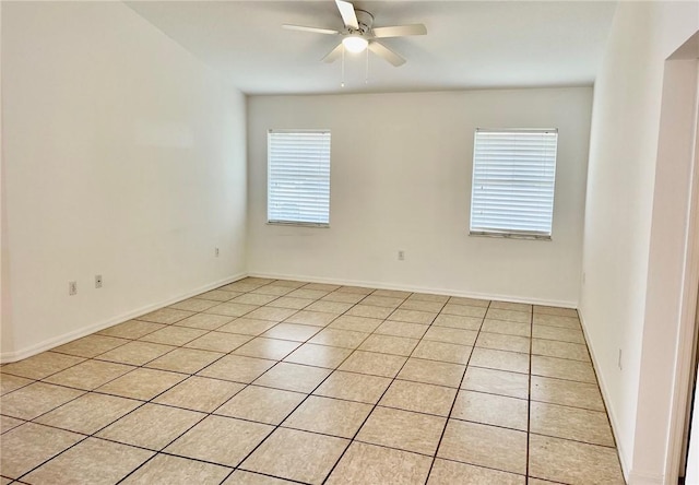 tiled spare room with ceiling fan