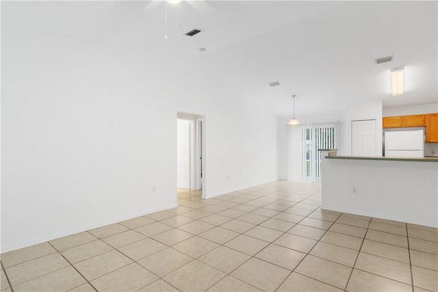 empty room featuring light tile patterned floors and ceiling fan