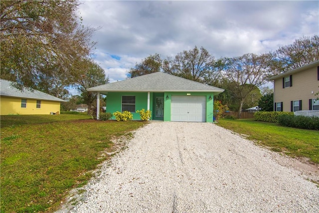 view of front of home with a garage, a front lawn, and covered porch