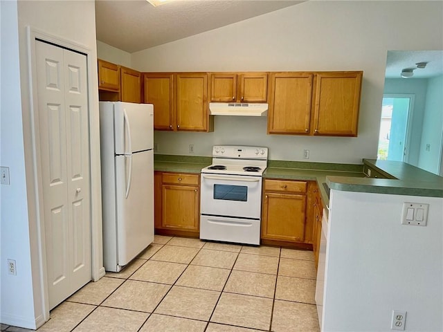 kitchen with vaulted ceiling, light tile patterned floors, white appliances, and kitchen peninsula