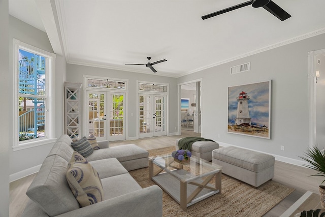 living room with french doors, light hardwood / wood-style flooring, ceiling fan, and crown molding