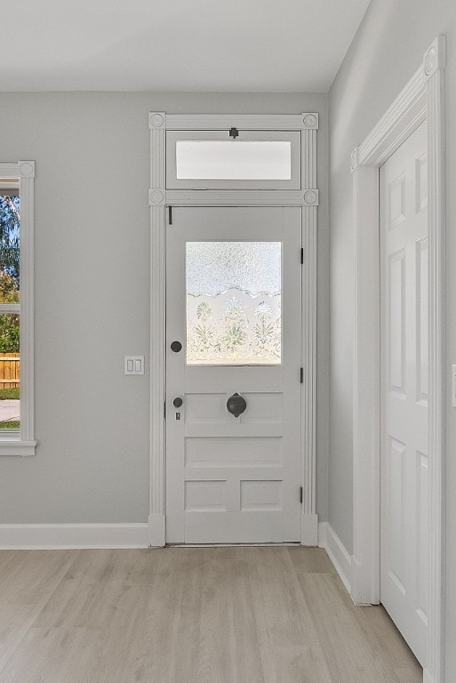 doorway to outside featuring light hardwood / wood-style floors and a healthy amount of sunlight