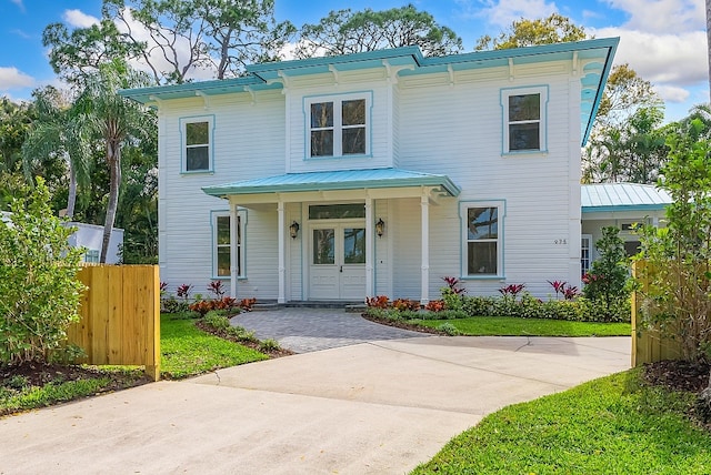 italianate-style house featuring a porch and a front yard