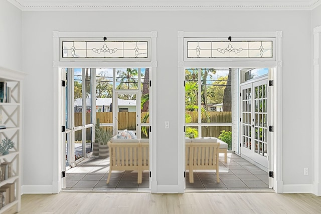 entryway with ornamental molding, french doors, hardwood / wood-style flooring, and a healthy amount of sunlight