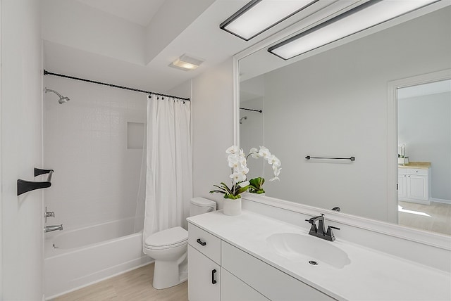 full bathroom featuring toilet, vanity, hardwood / wood-style flooring, and shower / bathtub combination with curtain