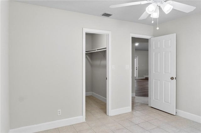 unfurnished bedroom with ceiling fan, light tile patterned floors, and a closet