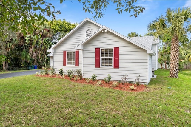 view of side of property with a yard