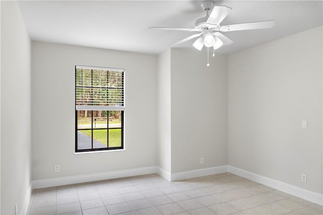 tiled spare room featuring ceiling fan and a wealth of natural light