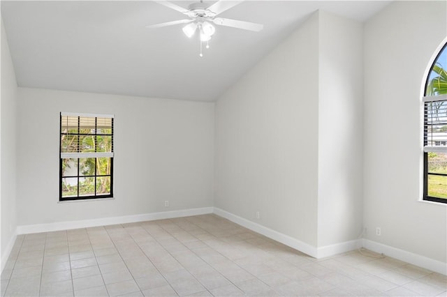 tiled empty room featuring vaulted ceiling and ceiling fan