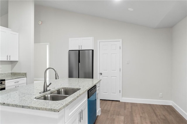 kitchen with sink, dishwashing machine, stainless steel fridge, and a kitchen island with sink