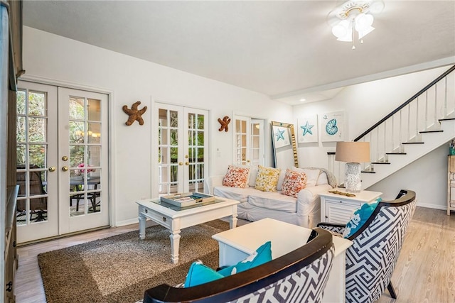 living room with stairs, french doors, wood finished floors, ceiling fan, and baseboards