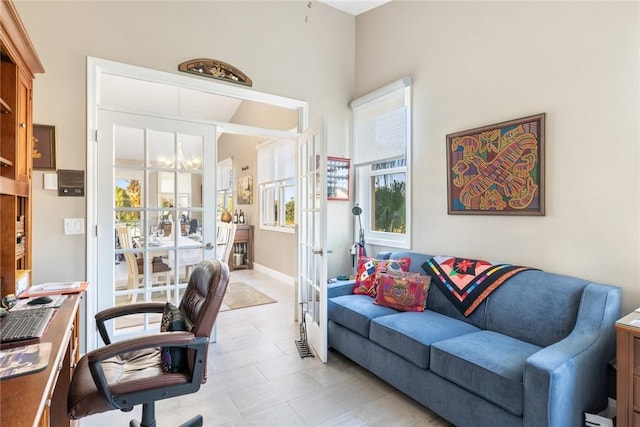 4877 N Newport Island Dr Unit 14D, Vero Beach, FL 32967 - home office with plenty of natural light, french doors, light tile patterned floors, and a chandelier