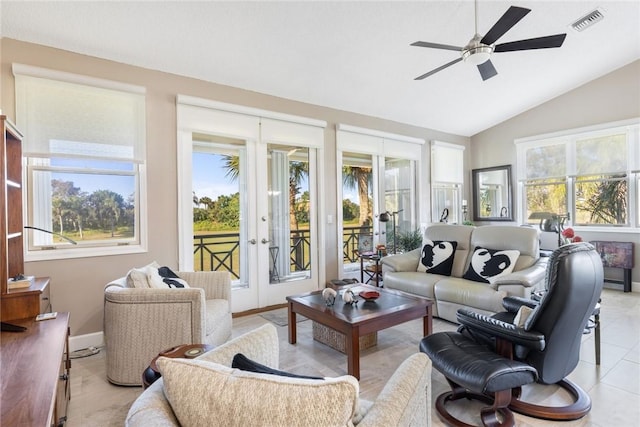 living room with ceiling fan, plenty of natural light, and vaulted ceiling