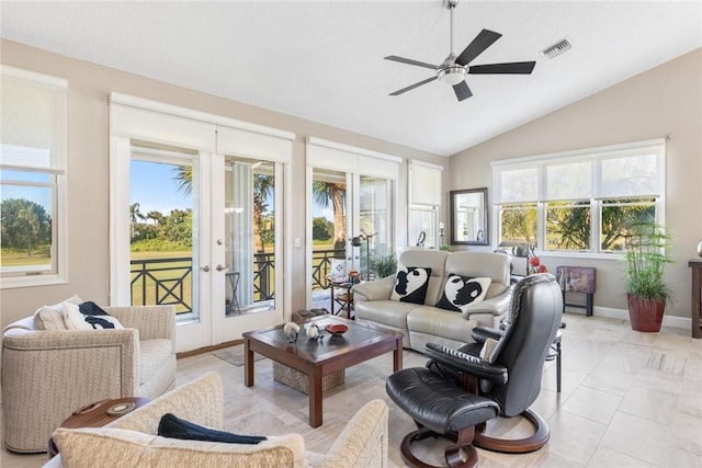 tiled living room with french doors, ceiling fan, and lofted ceiling