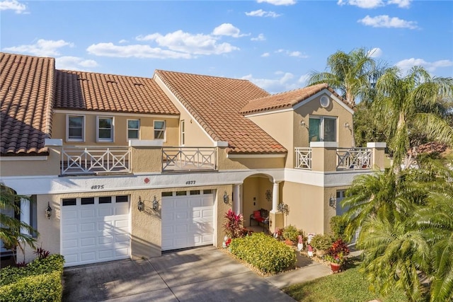 mediterranean / spanish-style house with a balcony and a garage