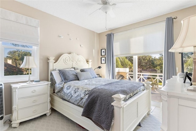 bedroom with a textured ceiling and ceiling fan