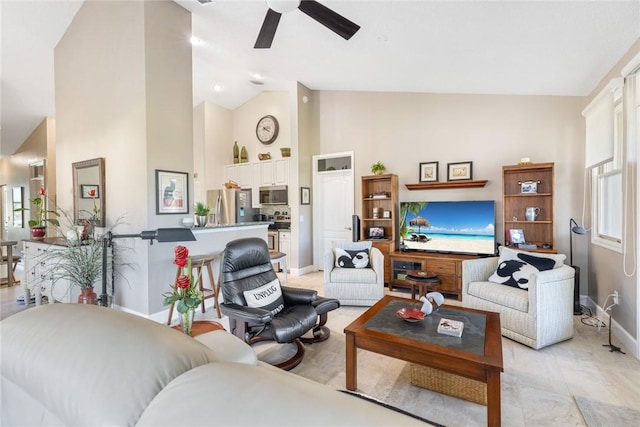 living room featuring ceiling fan and high vaulted ceiling