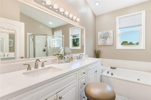 bathroom featuring vanity, a healthy amount of sunlight, lofted ceiling, and plus walk in shower