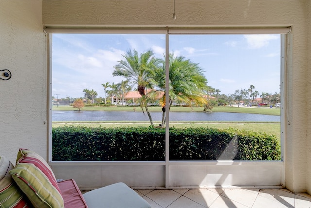 sunroom with a wealth of natural light and a water view