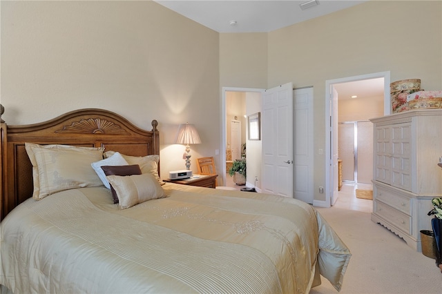 bedroom featuring a towering ceiling and light carpet