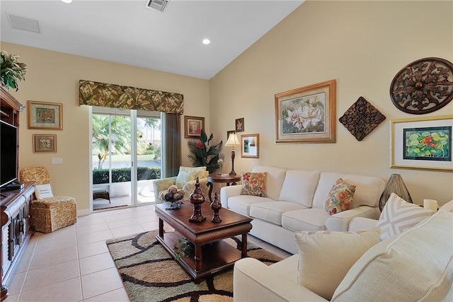 living room featuring lofted ceiling and light tile patterned floors