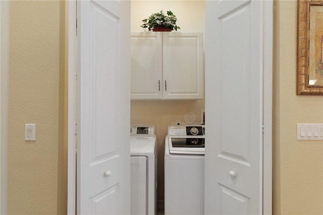 laundry area with cabinets and washer and dryer