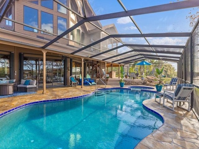 pool featuring glass enclosure, a patio area, and an in ground hot tub