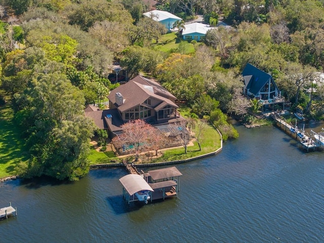 birds eye view of property with a water view