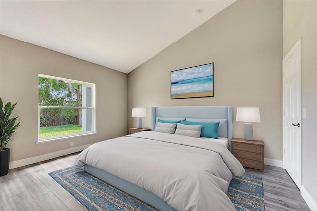 11126 Roseland Rd, Sebastian, FL 32958 - bedroom featuring vaulted ceiling, light wood-type flooring, and baseboards